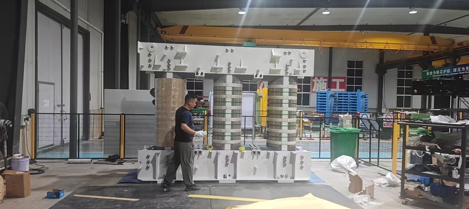 Large transformer core with white clamping frames in the workshop