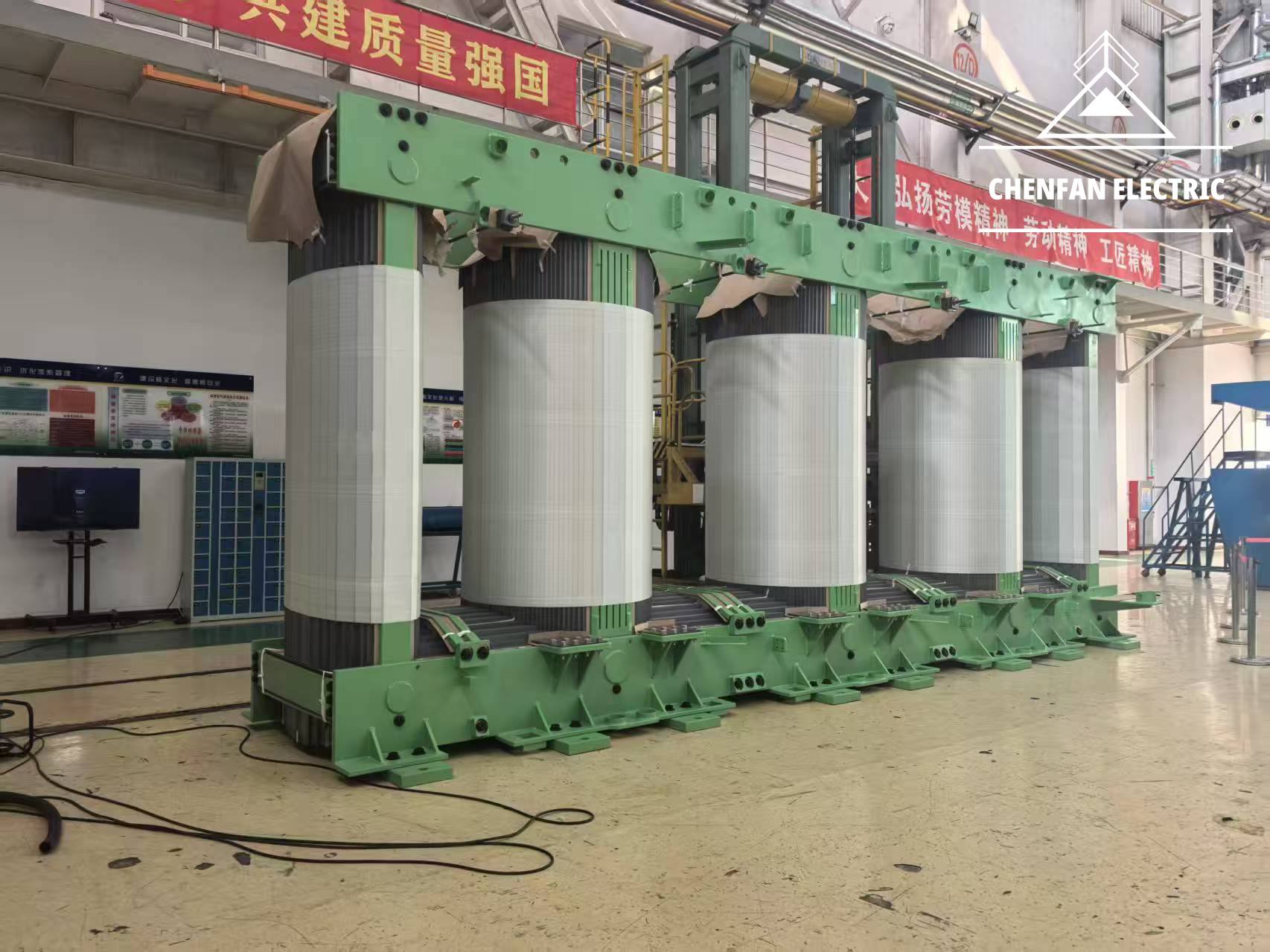 Large five-limb transformer core with green clamping frames